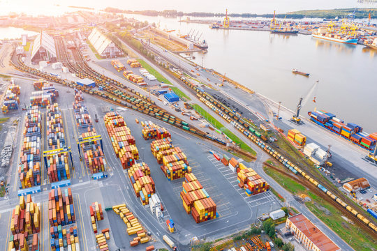 Panoramic Aerial Top View From The Heights Of The Cityscape Port Harbor And Industrial Area, Container Warehouse And Railway System Network Leading To The Seaport.