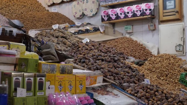 Selection of different arabian spices cosmetics on a traditional Moroccan market souk in Marrakech, Morocco. A lot of pepper, cardamon, cumin, curry