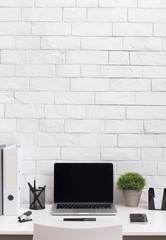 Obraz na płótnie Canvas Modern white office desk with blank screen on laptop