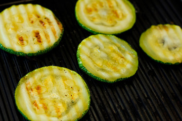 Zucchini sliced ​​rings fried, grilled, vegetables cooked on grill. Vegan or vegetarian food, meal. 