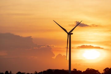 Obraz premium silhouette of wind turbine located on a ridge with wind blowing all the time. Making it able to effectively produce renewable electricity, which is another clean energy.