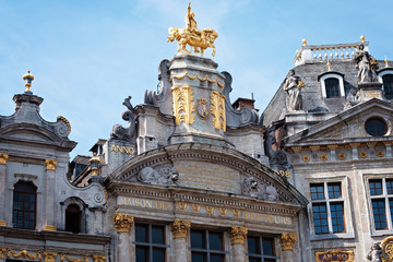 Fototapeta na wymiar Grand place in Brussels with golden ornaments and blue sky