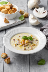 Cheese soup with mushrooms, potatoes, carrots and croutons Delicious cozy first course, autumn food