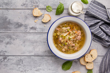 Vegetable soup with cabbage, meat, potatoes, zucchini, carrots, green peas, sour cream and bread. Delicious lunch, traditional first course, Russian