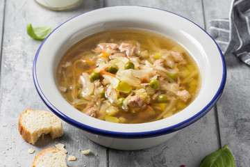 Vegetable soup with cabbage, meat, potatoes, zucchini, carrots, green peas, sour cream and bread. Delicious lunch, traditional first course, Russian