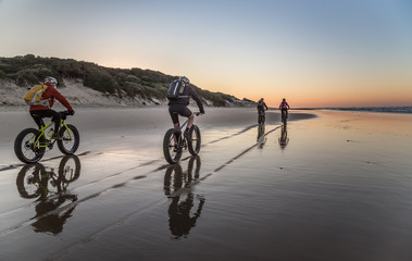 Cycling on the beach at dawn