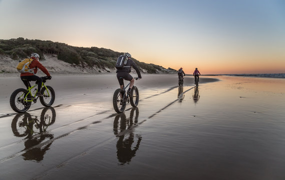 Cycling on the beach at dawn