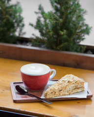 Cup of coffee and cake on a wooden table