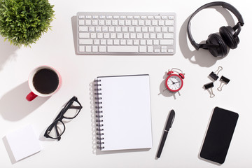 White office desk table with blank notebook