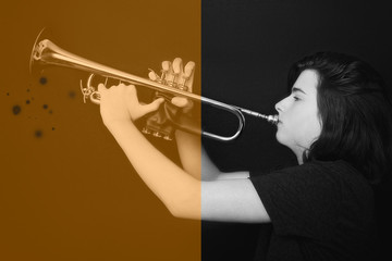 Portrait of a teenager with trumpet in studio.