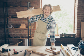 Portrait of his he nice attractive handsome blond cheerful content successful guy skilled artisan builder carrying long board at industrial brick loft style interior workplace