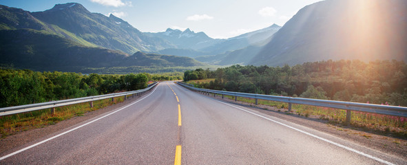 Highway in the mountains on the Loften Islands in Norway, beautiful landscape, sunset light © olezzo