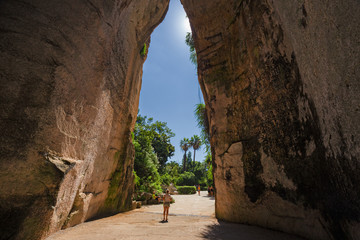 Exit of the excavated cave, called Orecchio di Dioniso, near the Greek theater of Syracuse, in Sicily Italy. - obrazy, fototapety, plakaty