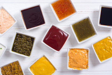 Set of different sauces in ceramic bowl