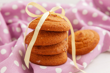 Close up of sweet tiny cookies stacked on a wooden table