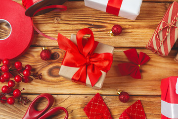 Fototapeta premium wrapping gift boxes with equipment and decorating items on wooden background