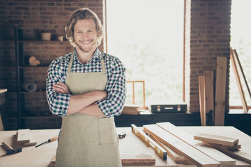 Portrait of his he attractive handsome cheerful cheery guy woodworker furniture building folded arms at industrial brick loft style interior indoors