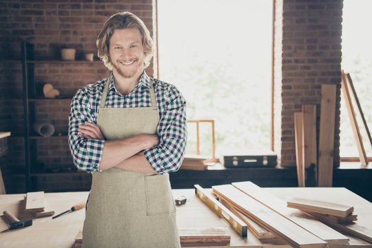 Portrait of his he attractive handsome cheerful cheery guy woodworker furniture building folded arms at industrial brick loft style interior indoors