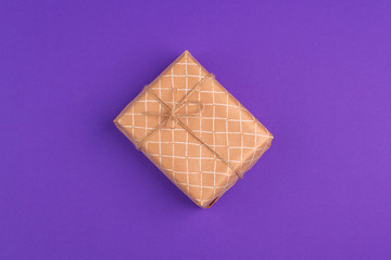 beautiful gift box wrapped in holiday paper with bow, top view