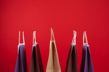 Several shopping bags with copy space on red background