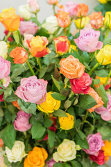 Obraz na płótnie Canvas Bright multicolored bouquet of roses. Natural flowers background, soft focus. Colorful roses flower background, group of multicolor rose make from clay, handmade product. vertical photo