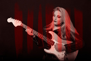 Obraz premium Beautiful blonde girl in rock style on a black background.