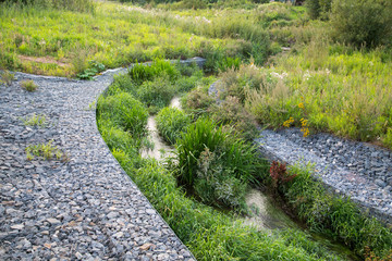 Channel of granite stones for the river stream. Landscaping Of the city.