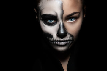 Halloween. Portrait of young beautiful girl with make-up skeleton on her face