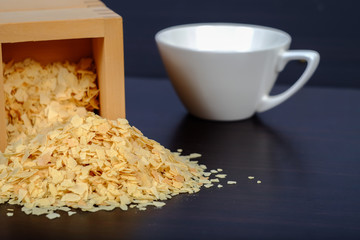 Cornflakes in wood box on a dark wooden background and copy