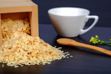 Cornflakes in wood box on a dark wooden background and copy
