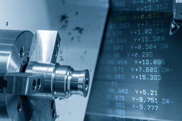 The abstract scene of CNC lathe machine. The turning machine cutting the metal shaft parts with...
