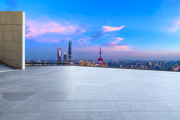 Empty square floor and city skyline with buildings at night in Shanghai,China.
