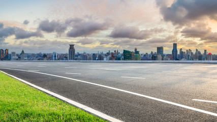 Empty highway and city skyline with buildings at sunset in Shanghai,China.