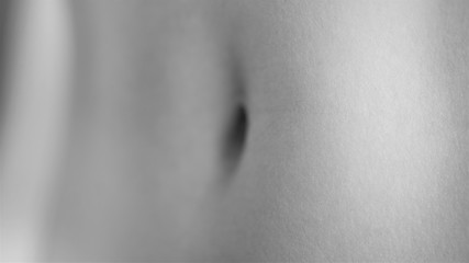female belly with navel close-up, perspective view, bw