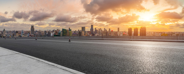 Empty highway and city skyline with buildings at sunset in Shanghai,China.