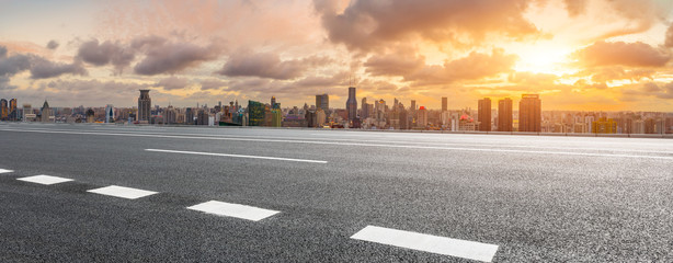 Empty highway and city skyline with buildings at sunset in Shanghai,China.