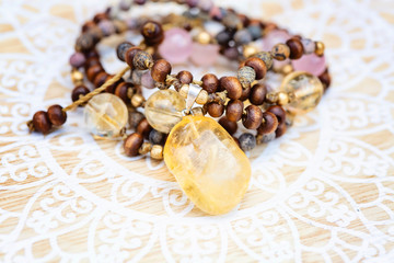 Citrine mineral stone pendant natural beads necklace on decorative background