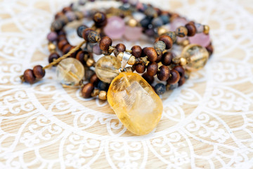 Citrine mineral stone pendant natural beads necklace on decorative background