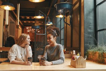 Sharing energy and ideas. Businesswomen have a meeting in a modern cafe