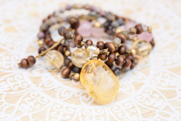 Citrine mineral stone pendant natural beads necklace on decorative background