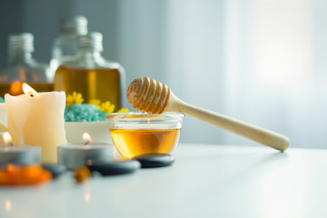 Closeup on honey spa therapy ingredients and salt spa objects on table,wellness and relaxation concept