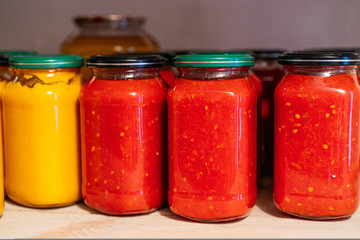 Composition with jars of pickled vegetables. Marinated food.