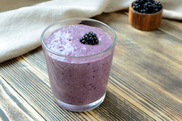 Delicious smoothie with organic blackberries in a transparent glass Healthy eating concept