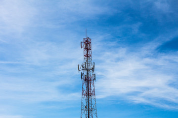 tower of communications with a lot of different antennas under beautiful sky.