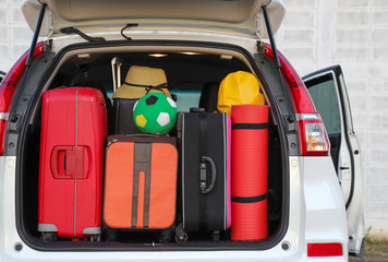 Closeup of rear side of white car with luggage, suitcases and things. Preparation for lovely family...