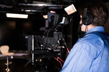 Camera Operator Filming in a Studio