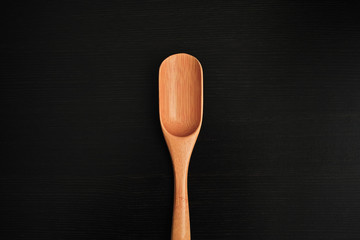wooden spoon isolated on black background close up