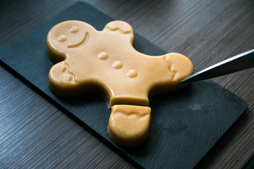 cutting off a leg of delicious seasonal fudge gingerbread man 