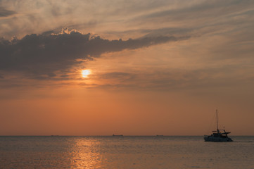 A beautiful sunset on the sea in the summer with a tender pink and orange and lilac color