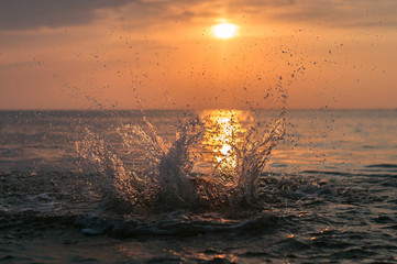 A water splash with a sunset on the background
